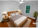 Bright bedroom showcasing hardwood floors, a comfortable bed, and soft, natural light at 10518 Fairway Ridge Rd, Charlotte, NC 28277
