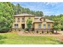 Beautiful two-story home with stone accents, lush landscaping, and inviting walkway at 11052 Preservation Park Dr, Charlotte, NC 28214