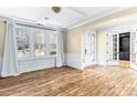 Elegant living room featuring wood floors, decorative molding, and an arched doorway at 11052 Preservation Park Dr, Charlotte, NC 28214