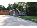Inviting single-story home with a long driveway and cozy covered front porch at 1109 Edwards St, Rock Hill, SC 29732