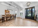 Bright dining room with coffered ceilings, wainscoting, and an elegant chandelier at 1149 Rosecliff Dr, Waxhaw, NC 28173