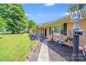 Inviting brick home featuring a landscaped front yard and covered entryway at 1204 N 12Th St, Bessemer City, NC 28016