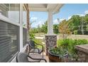 Inviting front porch with comfortable seating and decorative planters, perfect for relaxing outdoors at 15023 Longmoore Dr, Charlotte, NC 28278
