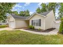 Angle-shot of a single-Gathering home with well-maintained lawn, walkway, and two-car garage on a sunny day at 1776 Baylor Dr, Rock Hill, SC 29732