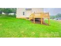 Backyard with a wooden deck leading from the house, and a grassy yard at 1872 Terrain Nw Dr, Conover, NC 28613