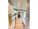 Bright kitchen features granite countertops, white cabinets, and stainless steel appliances at 1872 Terrain Nw Dr, Conover, NC 28613