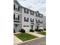 A row of attractive two-story townhomes, each featuring a garage and colorful front doors at 2037 Langer St, Charlotte, NC 28214