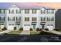 Charming townhomes feature attached garages, colorful entry doors, and well-maintained front lawns at 2037 Langer St, Charlotte, NC 28214