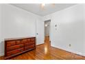 Cozy bedroom with hardwood floors, a vintage dresser, and plenty of natural light at 2255 Milton Rd, Charlotte, NC 28215