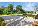 Long driveway leading to property surrounded by mature trees at 253 Hall Nw Ave, Concord, NC 28027