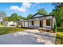 Lovely renovated bungalow highlighting its charming front porch and newly installed driveway at 253 Hall Nw Ave, Concord, NC 28027