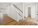 Inviting hallway and staircase with hard surface floors and neutral color palette at 2588 Blue Sky Meadows Dr, Monroe, NC 28110