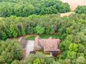 An aerial view shows this brick home nestled amongst mature trees on a sprawling lot at 270 North St, Salisbury, NC 28147