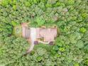 From above, this brick home is surrounded by dense trees, providing shade and privacy at 270 North St, Salisbury, NC 28147