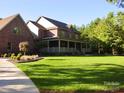 Charming brick home showcasing a spacious front yard, mature trees, and a welcoming covered porch at 270 North St, Salisbury, NC 28147
