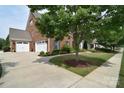 A brick house with a three-car garage and well-maintained landscaping at 2812 Julian Glen Cir, Waxhaw, NC 28173