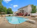 Expansive backyard with a refreshing pool, diving board, and an entertainment area with built-in grill at 3038 Sterling Ct, Fort Mill, SC 29707