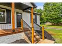 Close-up of the home's front porch highlighting the columns, stairs and design details at 320 E Pine St, Maiden, NC 28650