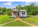Cozy home with a well-maintained front yard and walkway to the front entrance at 320 E Pine St, Maiden, NC 28650
