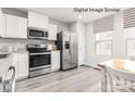 Well-equipped kitchen with stainless steel appliances, white cabinets, and durable countertops at 3233 Dannelly Towns Aly # 1002C, Charlotte, NC 28208