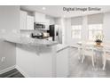 Bright eat-in kitchen featuring white cabinets, stainless steel appliances, and a cozy dining area at 3233 Dannelly Towns Aly # 1002C, Charlotte, NC 28208