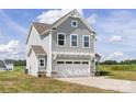 Charming two-story home with gray siding, a two car garage, and a well-manicured lawn at 32562-B Millingport Rd # 7155, New London, NC 28127
