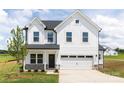 New two-story home with white siding, black door, two car garage, and manicured landscaping at 32616 Millingport Rd # 7144, New London, NC 28127