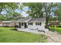 Single-story home with a white brick exterior, black trim, and manicured lawn at 330 Willow Oak Cir, Lancaster, SC 29720