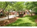 Brick home with mature trees, green lawn, and circular driveway at 3504 High Ridge Rd, Charlotte, NC 29270