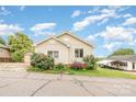 Charming single-story home with vinyl siding and colorful landscaping under a partly cloudy sky at 380 Woodlawn Ave, Cramerton, NC 28032
