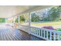 Inviting front porch with wooden floors and a view of the landscaped yard at 3921 Bon Rea Dr, Charlotte, NC 28226