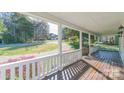 Spacious front porch with white railings and a view of the surrounding greenery at 3921 Bon Rea Dr, Charlotte, NC 28226