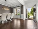 Formal dining room with stylish light fixture, hardwood floors, and large window at 4013 Hamilton Mill Dr, Waxhaw, NC 28173