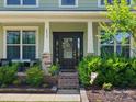 Close-up of the home's front door, featuring a decorative wreath and manicured landscaping at 4013 Hamilton Mill Dr, Waxhaw, NC 28173