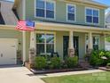 Inviting front porch with a cozy seating area and tasteful landscaping, perfect for relaxation at 4013 Hamilton Mill Dr, Waxhaw, NC 28173