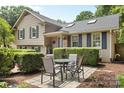 Charming home featuring a cozy outdoor seating area with a table and chairs on a paved patio at 4024 Tyndale Ave, Charlotte, NC 28210