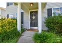 Charming front door with decorative wreath and landscaping at 4075 Clover Nw Rd, Concord, NC 28027