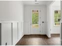 Bright foyer with wainscoting, hardwood floors, and front door view at 4315 Palm Dr, Denver, NC 28037