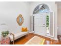 Bright foyer with hardwood floors, bench seating, decorative mirror, and ample natural light at 4409 Winder Trl, Gastonia, NC 28056