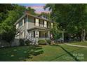 Charming two-story home with a well-kept lawn and mature trees, offering a peaceful suburban setting at 448 Union S St, Concord, NC 28025