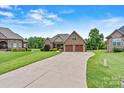 Well-maintained brick home with long driveway, showcasing a manicured lawn and attractive landscaping at 5163 Meadow Park Ln, Hickory, NC 28602