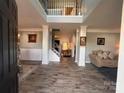 Grand foyer with high ceilings, wood floors, elegant columns, and open staircase at 5227 Eagle Creek Dv, Charlotte, NC 28269