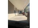 Spacious covered front porch with brick columns and ample room for outdoor seating, with sidewalk in view at 524 Railroad Nw Dr, Concord, NC 28025