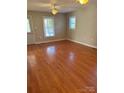 Bright living room with hardwood floors, natural light, and ceiling fan, offering a welcoming space at 524 Railroad Nw Dr, Concord, NC 28025