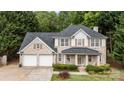 Attractive two-story brick home with a covered front porch, attached two-car garage, and mature landscaping at 5625 Linda Vista Ln, Charlotte, NC 28216
