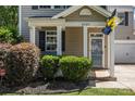 Inviting front porch with decorative columns, manicured bushes and the house number, creating curb appeal at 6107 Raisin Tree Ln, Charlotte, NC 28215