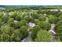 Expansive aerial view of a home nestled within a lush, tree-filled neighborhood and well manicured lawn at 641 Saratoga Dr, Clover, SC 29710