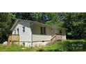 Cozy single-Gathering home featuring vinyl siding and a small front porch with wooden steps at 6653 Mountain Grove Rd, Hickory, NC 28658