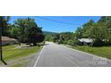 Open street view featuring trees and landscaping, with a glimpse of a mountain in the distance at 6653 Mountain Grove Rd, Hickory, NC 28658