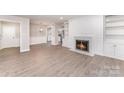 Living room featuring a fireplace with built-in shelving, and laminate floors at 7026 Quail Hill Rd, Charlotte, NC 28210